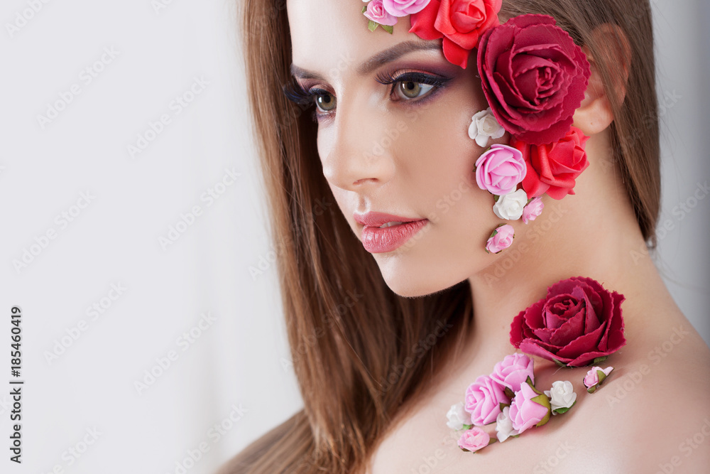 Beautiful young girl with applique flowers on the face.