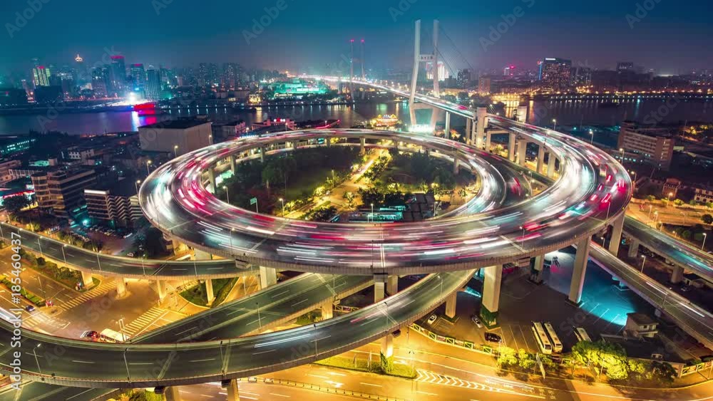 Famous highway intersection in Shanghai, China. Big modern city by night. Time lapse.
