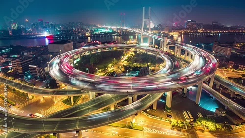 Famous highway intersection in Shanghai, China. Big modern city by night. Time lapse. 