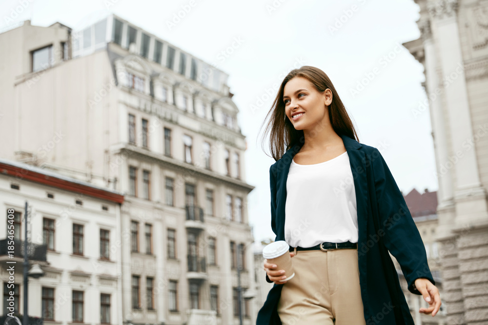 Beautiful Woman With Cup Of Coffee Walking On Street.