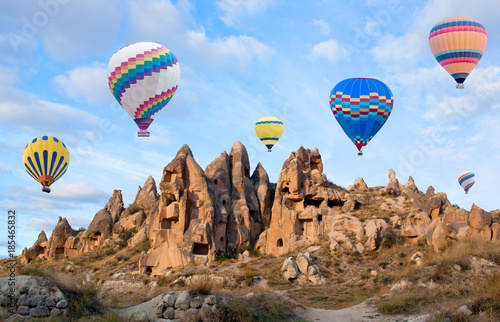 Colorful hot air balloons flying over the valley in Cappadocia, Anatolia, Turkey