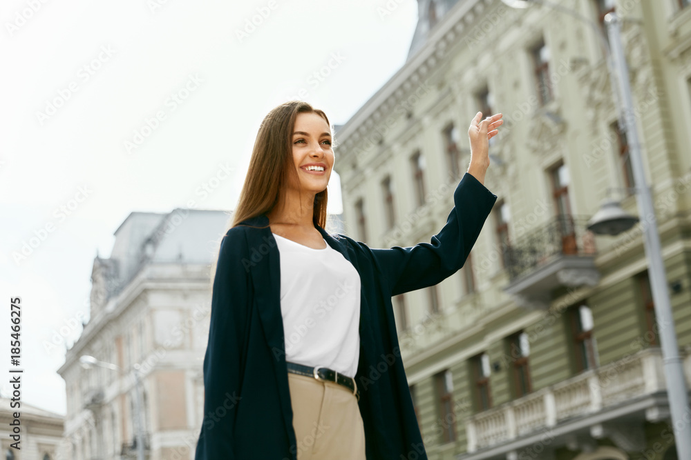 Fototapeta premium Beautiful Woman Catching Taxi Car On Street.