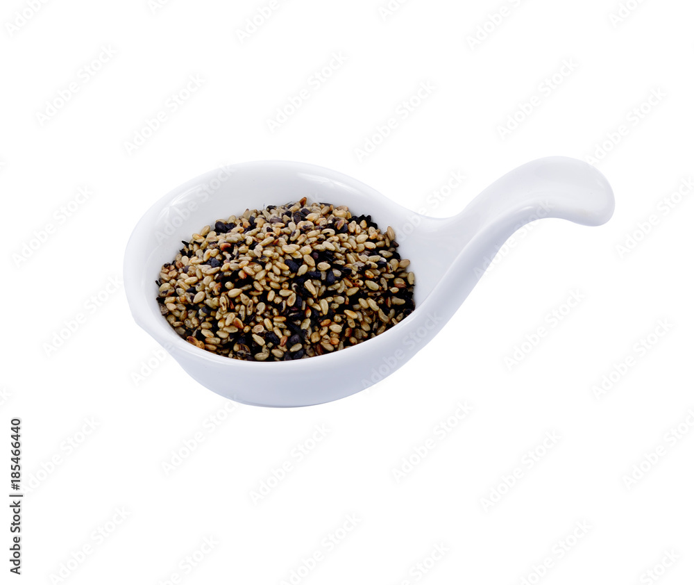 Sesame seeds in white spoons isolated on white background Sesame seeds in white spoons isolated on white background