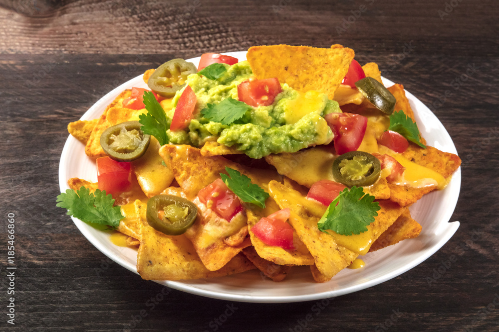Nachos with cheese and hot peppers, traditional Mexican snack Nachos with cheese and hot peppers, traditional Mexican snack