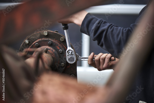 farmer repair his agricultural machine