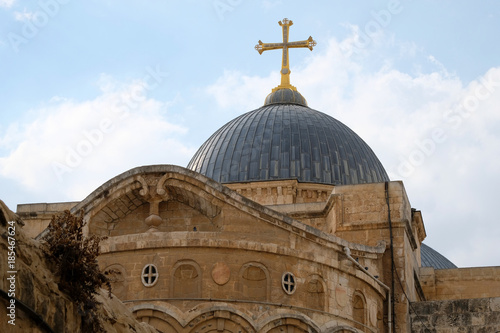Golden cross on the top of Holy Sepulcher church building in Jerusalem.