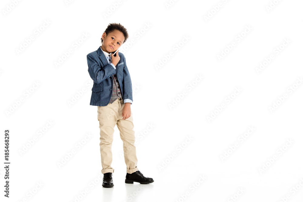 adorable african american kid talking by smartphone on white adorable african american kid talking by smartphone on white