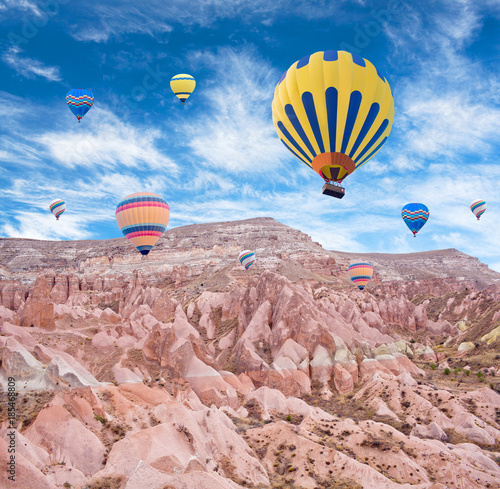 Colorful hot air balloons flying over the Red valley in Cappadocia, Anatolia, Turkey