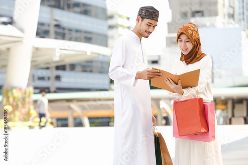 Muslim couple young girl and boy reading book with shopping in the city,Concept education and shopping
