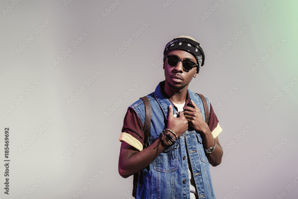 portrait of stylish young african american man in sunglasses posing isolated on grey portrait of stylish young african american man in sunglasses posing isolated on grey