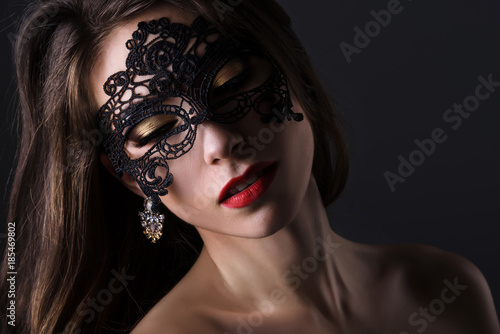 Attractive woman in lace mask. Portrait