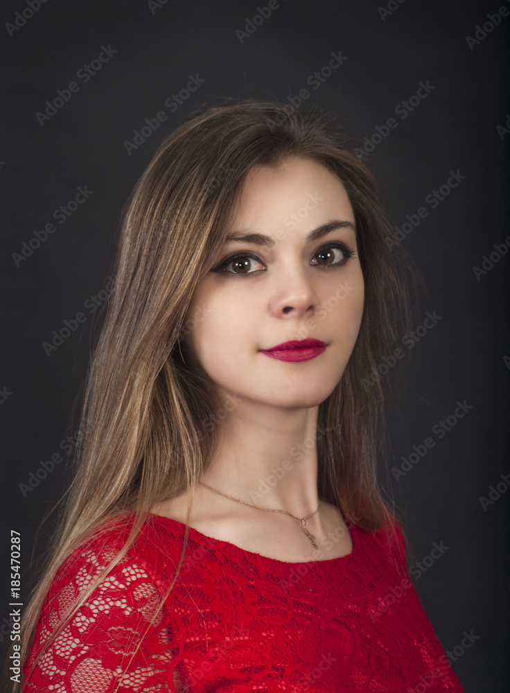 Portrait of a beautiful girl in a red dress. Portrait of a beautiful girl in a red dress.