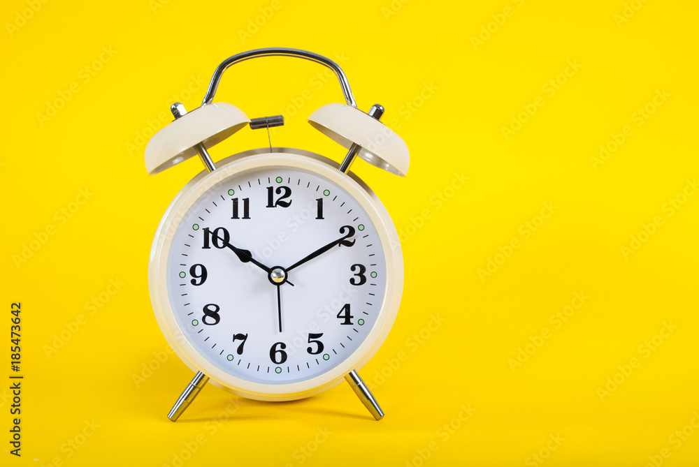 Old clock on yellow background and space for text Old clock on yellow background and space for text