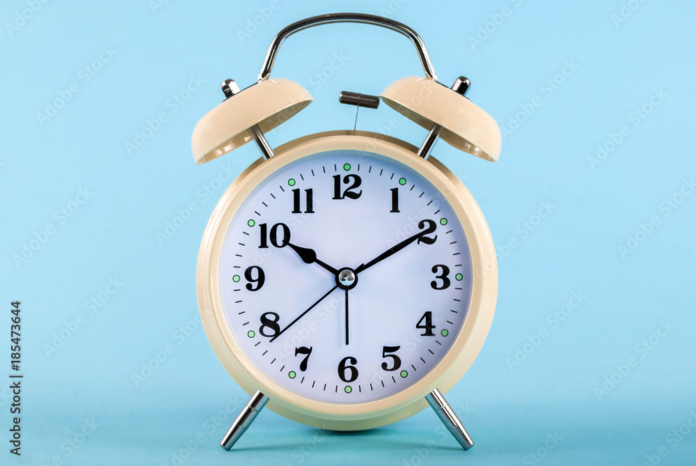 Retro alarm clock isolated on a blue background Retro alarm clock isolated on a blue background
