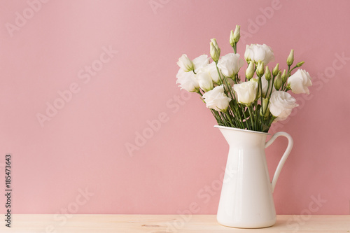 White roses in vintage vase photo