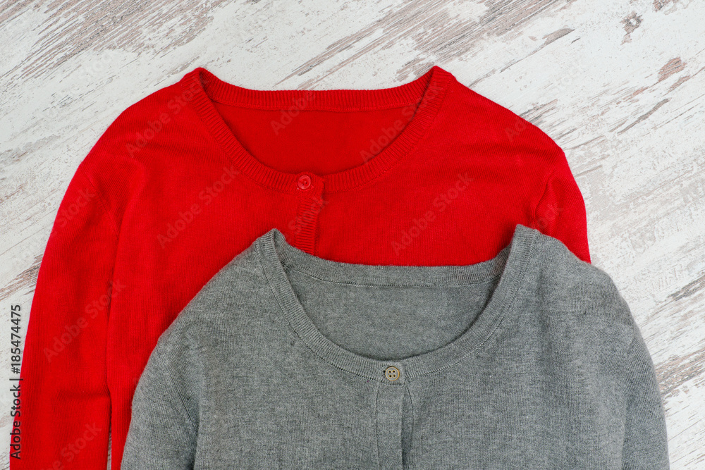 Two sweaters on a wooden background. Fashionable concept Two sweaters on a wooden background. Fashionable concept
