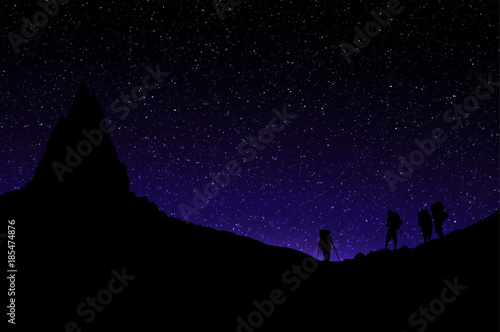 Silhouette of Mountainers Standing under Mountai Peak. Starry Sky.