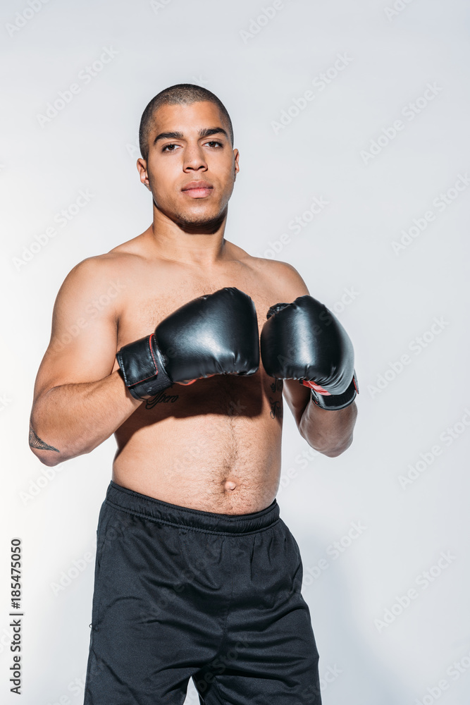 muscular african american sportsman with boxing gloves isolated on white