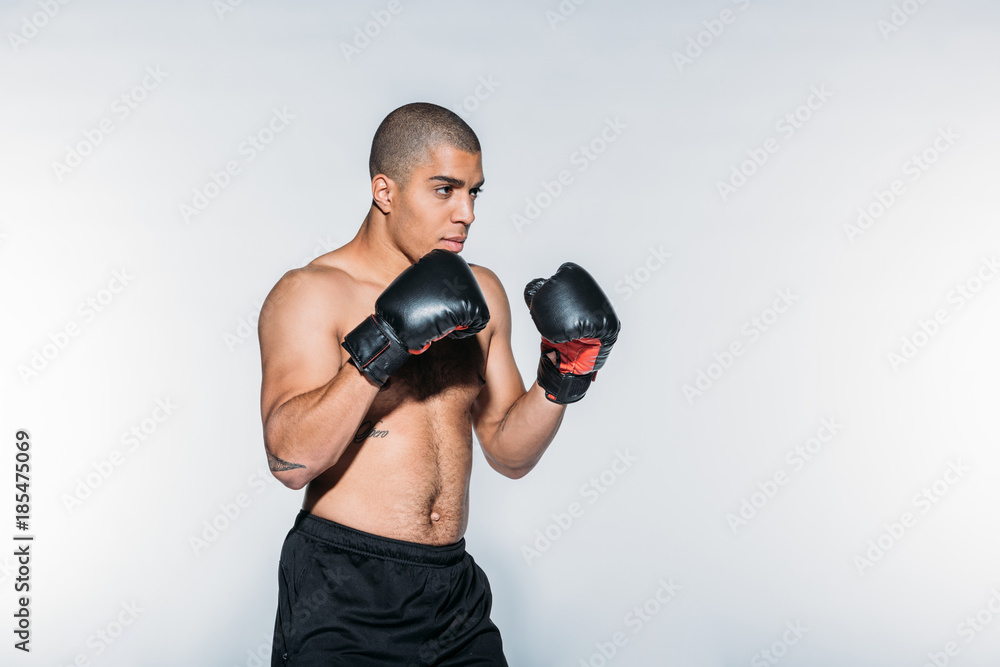 muscular african american boxer training isolated on white