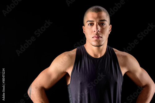serious african american man standing isolated on black