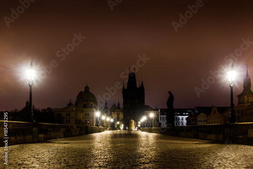 Charles bridge in Prague with lanterns at night © Sergey Fedoskin