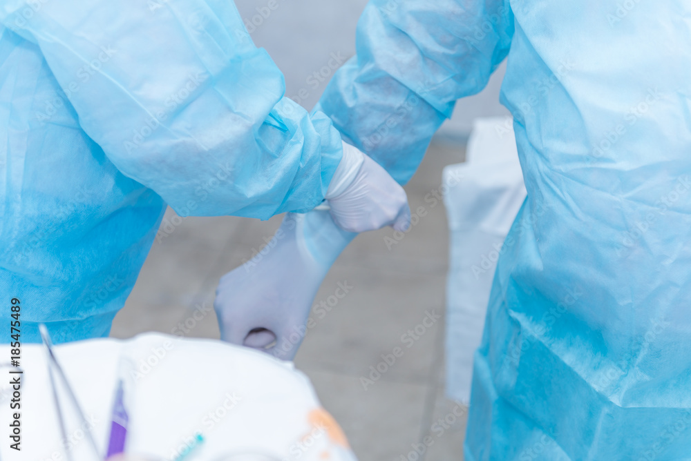 Fototapeta premium the hands of surgeons physicians doing surgery to the patient in the clinic, the concept of photo medicine, professional doctors, anesthesia