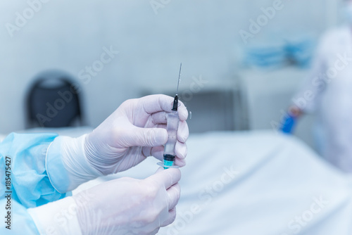 the hands of surgeons physicians doing surgery to the patient in the clinic, the concept of photo medicine, professional doctors, anesthesia