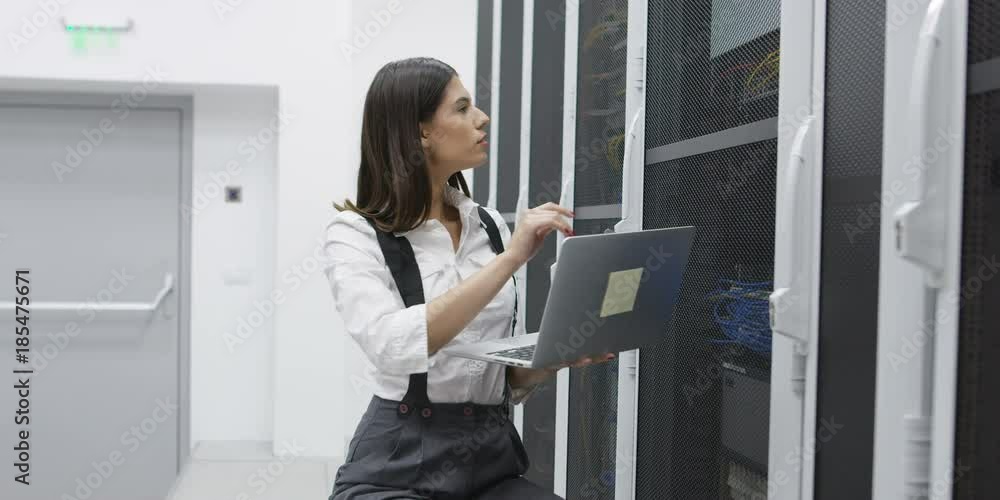 woman using computer in server room woman using computer in server room