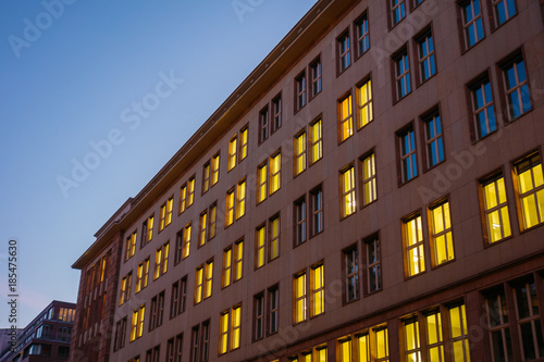 typical office house in berlin with yellow lights inside at night