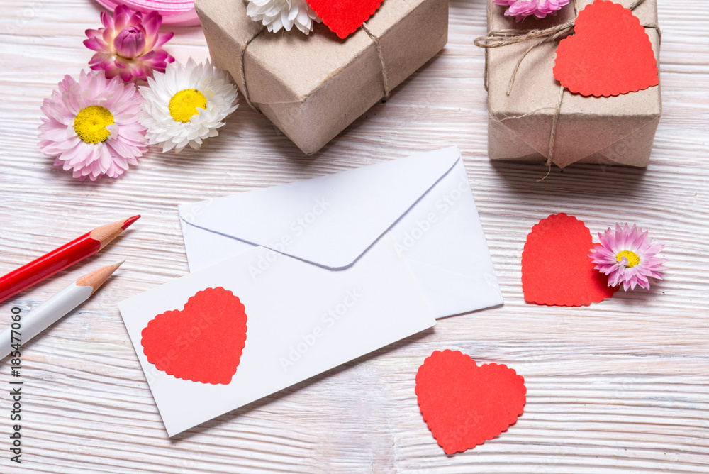 Preparing Valentine day gift, gift boxes and envelope on wooden background Preparing Valentine day gift, gift boxes and envelope on wooden background