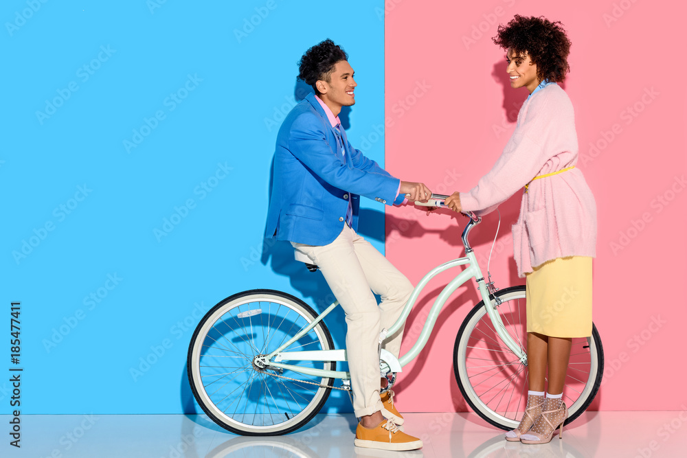Obraz premium lovely young couple hugging each other on pink and blue background