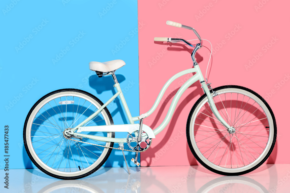 View of city bike on pink and blue background