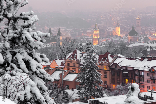 View to a winter night city covered with snow. Panorama of Lviv, Ukraine