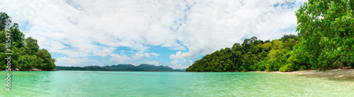 Idyllic tropical clear sea and green island panorama