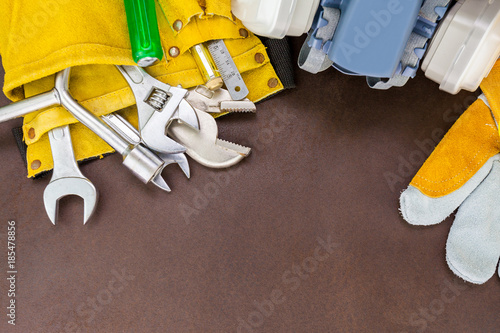 set of working tools on brown background
