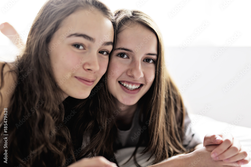 Friends in pajamas sitting in bed at home relaxing. Friends in pajamas sitting in bed at home relaxing.