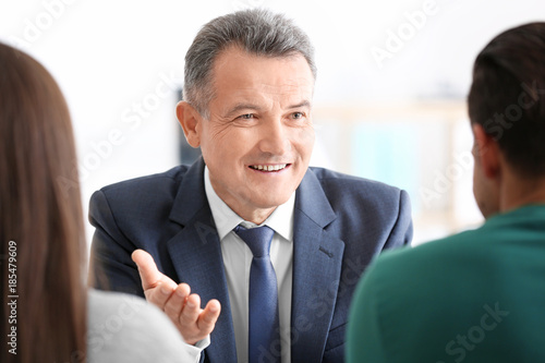 Notary public and young couple in office photo