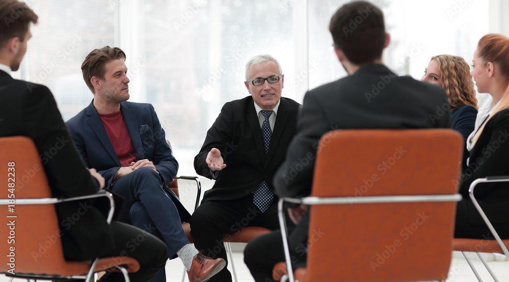 senior businessman holds a meeting with the business team senior businessman holds a meeting with the business team
