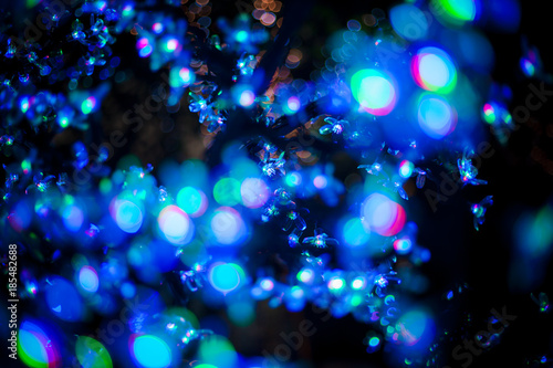 Abstract bokeh blue purple light glitter background for Christmas and New Year festival season