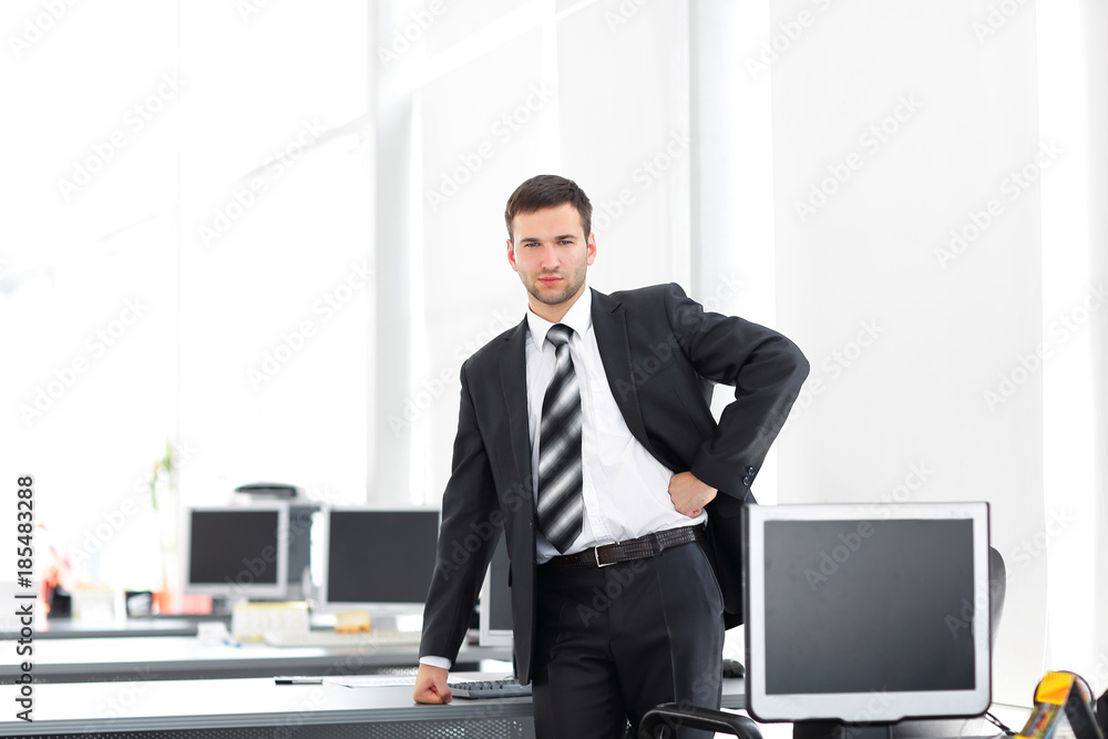 senior Manager standing in a modern office before the start of the working day senior Manager standing in a modern office before the start of the working day