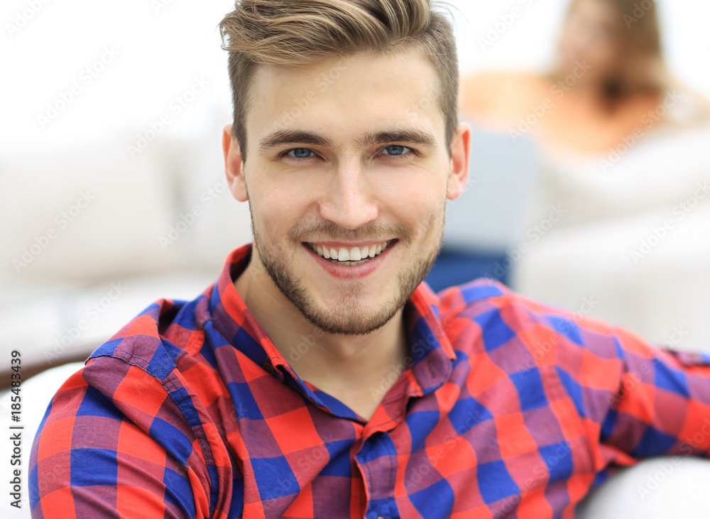 closeup portrait of young man sitting in a chair closeup portrait of young man sitting in a chair