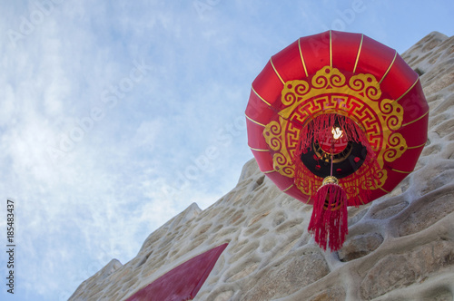 Red Chinese Lantern Hangs on a White Wall.