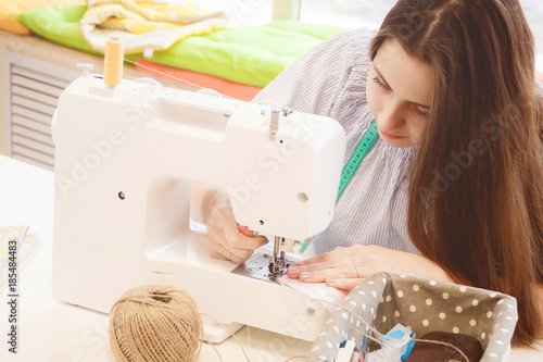 Woman seamstress work on sewing machine