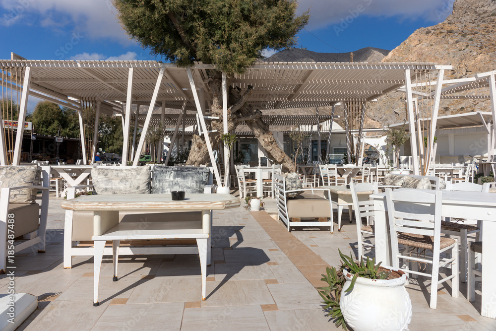 Outdoor restaurant by the beach in Perissa Santorini Greece