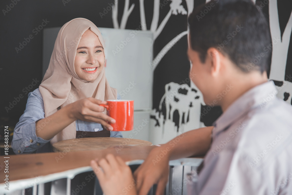 man sitting in a cafe bar served with coffee man sitting in a cafe bar served with coffee