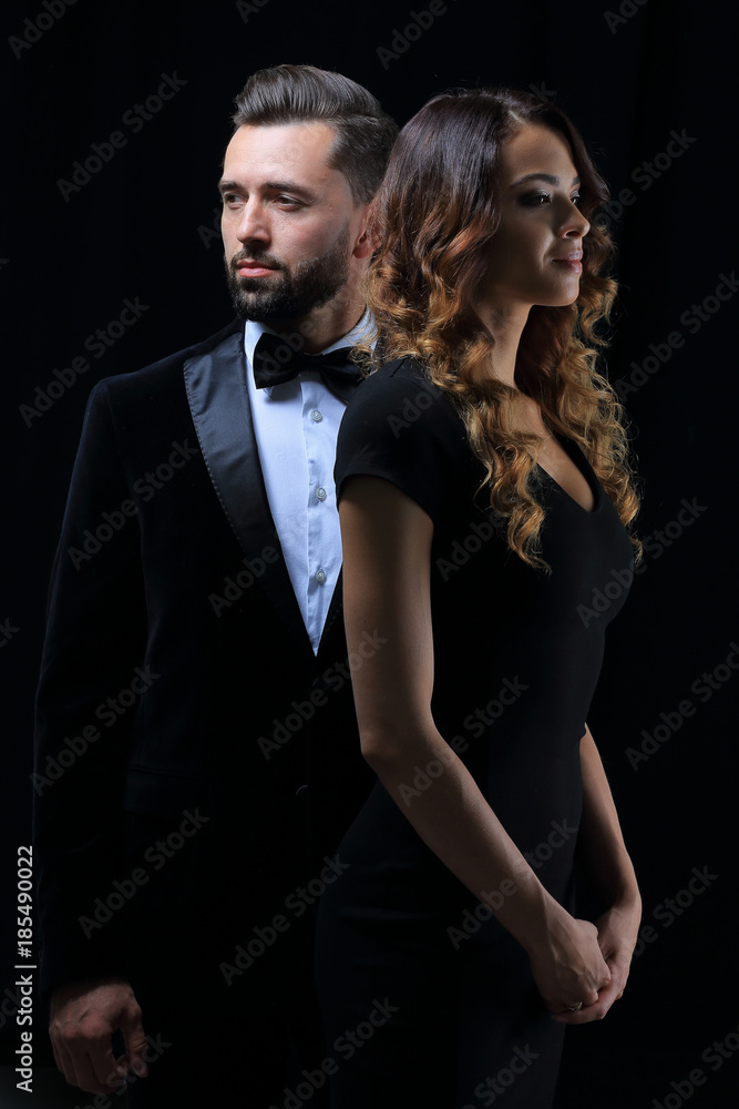 photo of young family couple on black background. photo of young family couple on black background.
