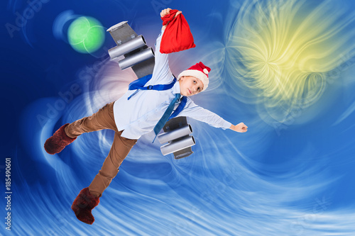 Young Santa Claus flying in the futuristic space sky with presents for Christmas on a jet pack © Yury Kisialiou