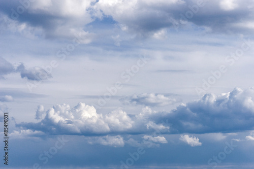 Beautiful heavenly landscape, soft white clouds with a light blue sky background in a warm day.