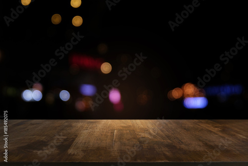 Empty dark wooden table in front of abstract blurred bokeh background of restaurant . can be used for display or montage your products.Mock up for space.