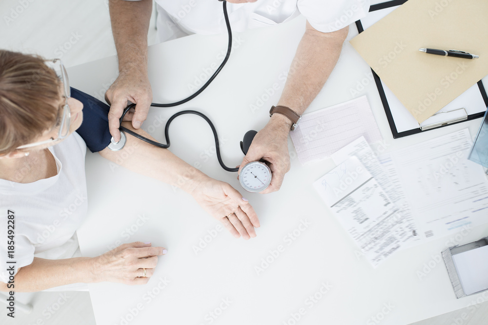 General doctor measuring blood pressure General doctor measuring blood pressure